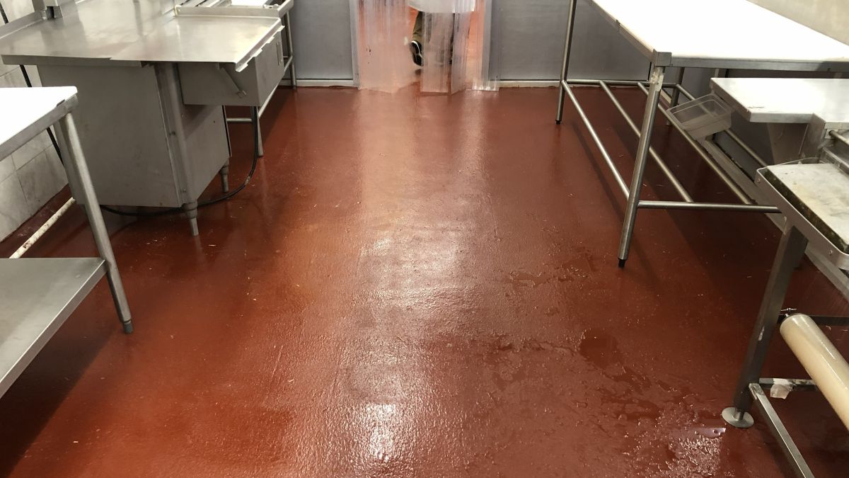 Heavy-duty installation of durable commercial kitchen flooring designed to withstand thermal shock and high-volume traffic.