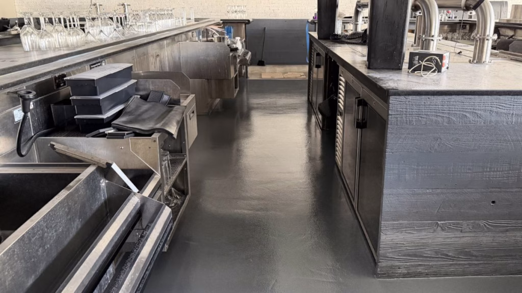 Industrial kitchen flooring installation featuring seamless urethane concrete and integrated drain preparation