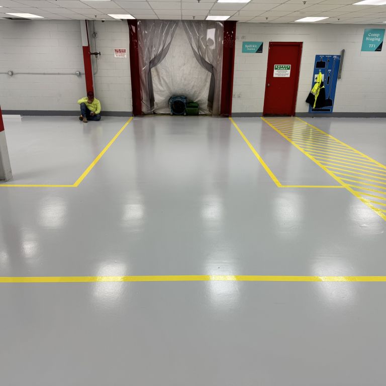 Heavy duty urethane cement flooring installed in a high traffic food processing facility to withstand forklift traffic