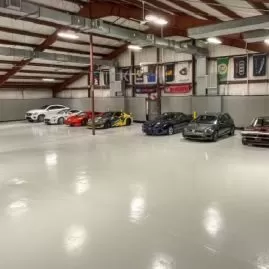 Automotive garage with vehicles parked on smooth epoxy coated floor