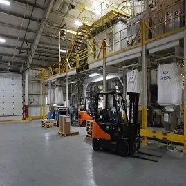 Manufacturing plant interior with forklift operating on coated concrete floor
