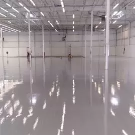 Empty warehouse with glossy floor and high ceiling