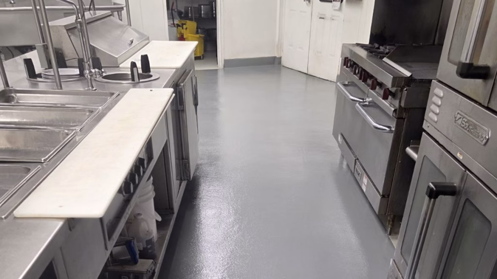 Professional installation of epoxy flooring for commercial kitchens in NJ, showing a seamless and slip-resistant surface.