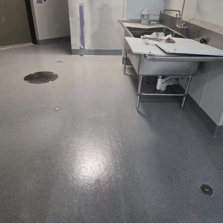 Professional installation of industrial liquid flooring systems for a high-traffic commercial kitchen.