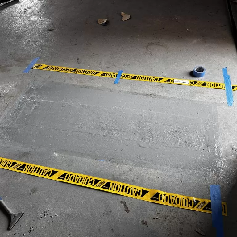 Industrial installation of a moisture vapor barrier to prevent hydrostatic pressure and floor delamination in a New Jersey warehouse.