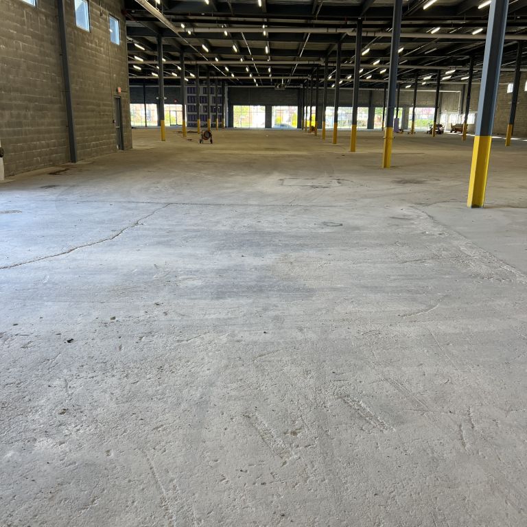 Concrete surface preparation and epoxy coating application at a logistics facility in Elizabeth, New Jersey.