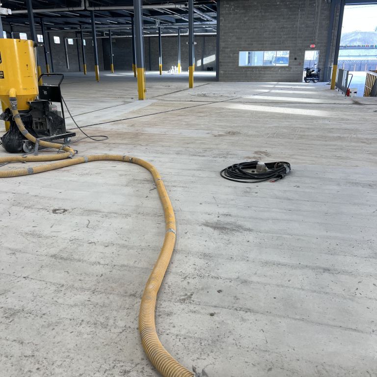 Concrete surface preparation and epoxy coating application at a logistics facility in Elizabeth, New Jersey.