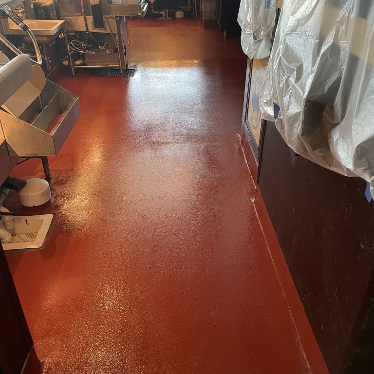 Commercial kitchen in Hoboken NJ featuring a seamless red urethane cement floor for high-temperature and slip resistance.