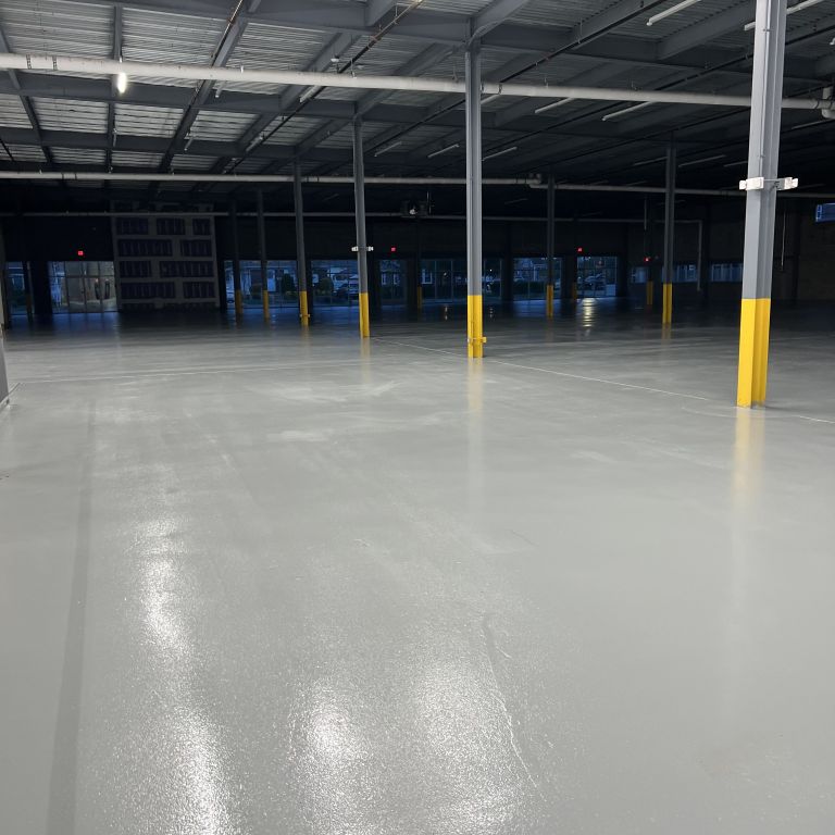 Durable, chemical-resistant resinous flooring system installed in a Newark industrial warehouse distribution center.