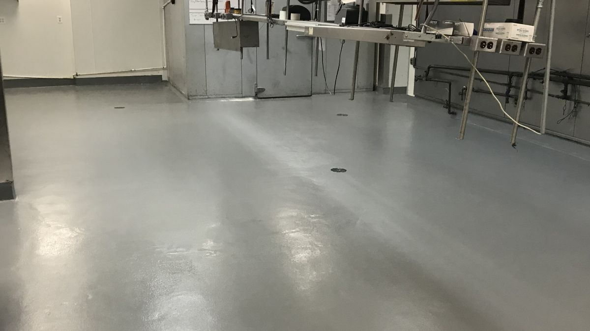 Industrial restaurant kitchen flooring in Ramsey NJ featuring a seamless, slip-resistant urethane concrete installation.