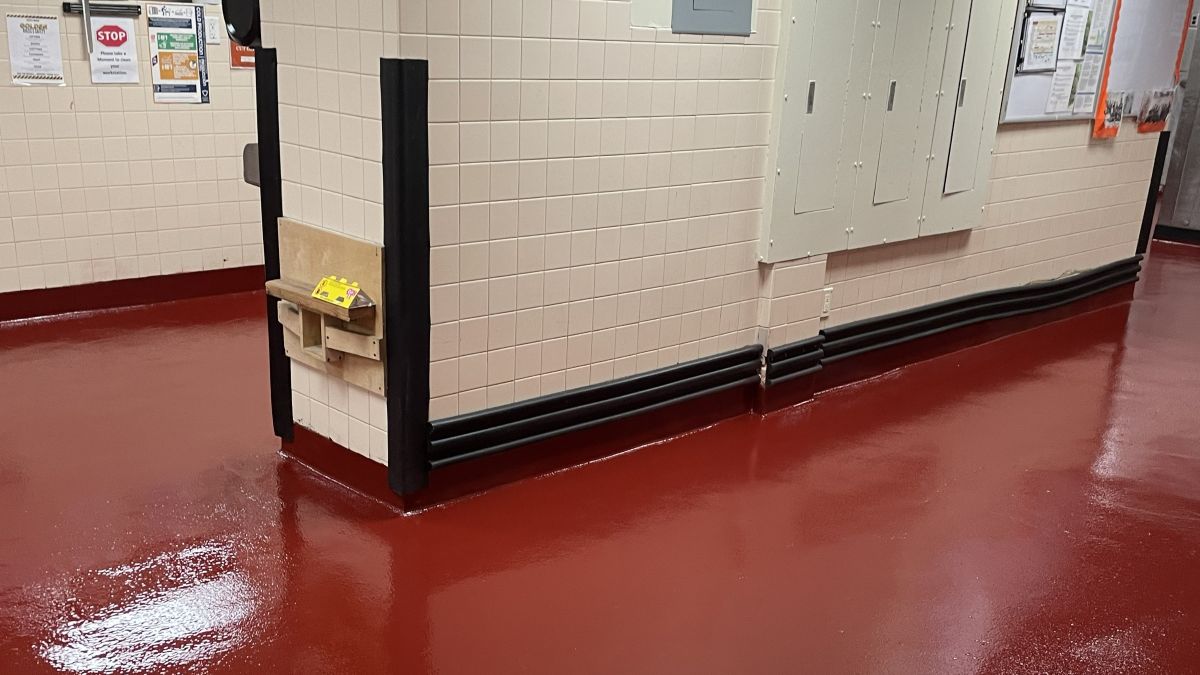 Seamless red urethane cement floor in a Hoboken NJ commercial kitchen providing thermal shock and slip resistance.