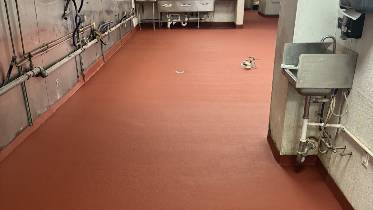 Industrial restaurant kitchen flooring installation in Edgewater NJ showing a seamless, slip-resistant surface.