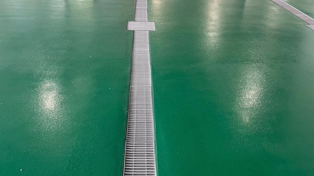 Seamless green urethane concrete floor completed by an industrial epoxy flooring contractor in a Newark, NJ food processing plant.