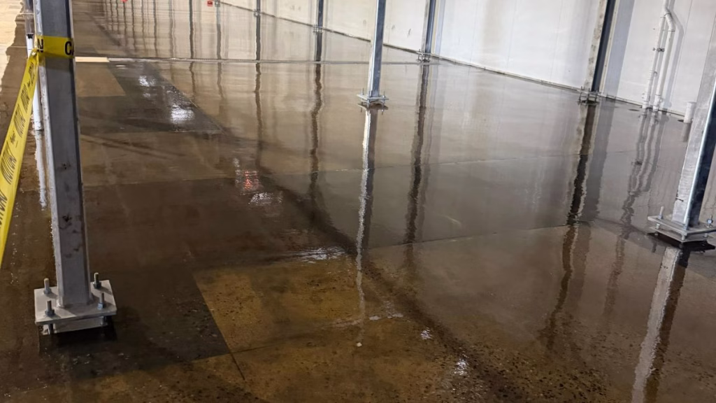 Commercial epoxy flooring contractor applying a durable, high-gloss resin system in an Edison, NJ industrial warehouse.